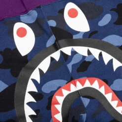 Crazy Camo Shark Sweat Shorts - Navy 9 Crazy Camo Shark Sweat Shorts - Navy -Feature store A Bathing Ape Crazy Camo Shark Sweat Shorts Navy 001SPI201003M NVY 01 03 23 Feature VR 6
